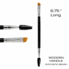 Close-up of professional dual-ended tint brush showing precision angled synthetic bristles, silver ferrules, black wooden handle and spiral spoolie.