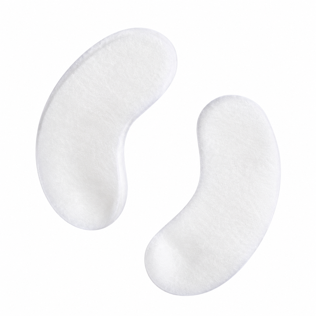 Two white, kidney-shaped eye pads on a solid white background. protection pads for professional lash and brow tinting