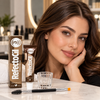 Brunette model with professionally defined natural brown brows beside RefectoCil No. 3 Natural Brown tint, mixing glass and dual-ended brow brush in a salon